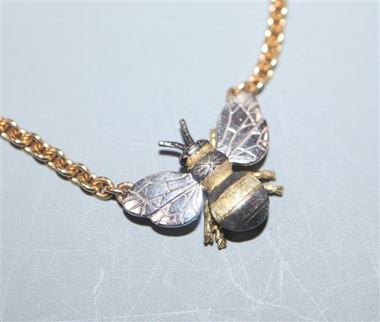 A yellow and white metal bee pendant on 18ct yellow gold chain, gross 11 grams.